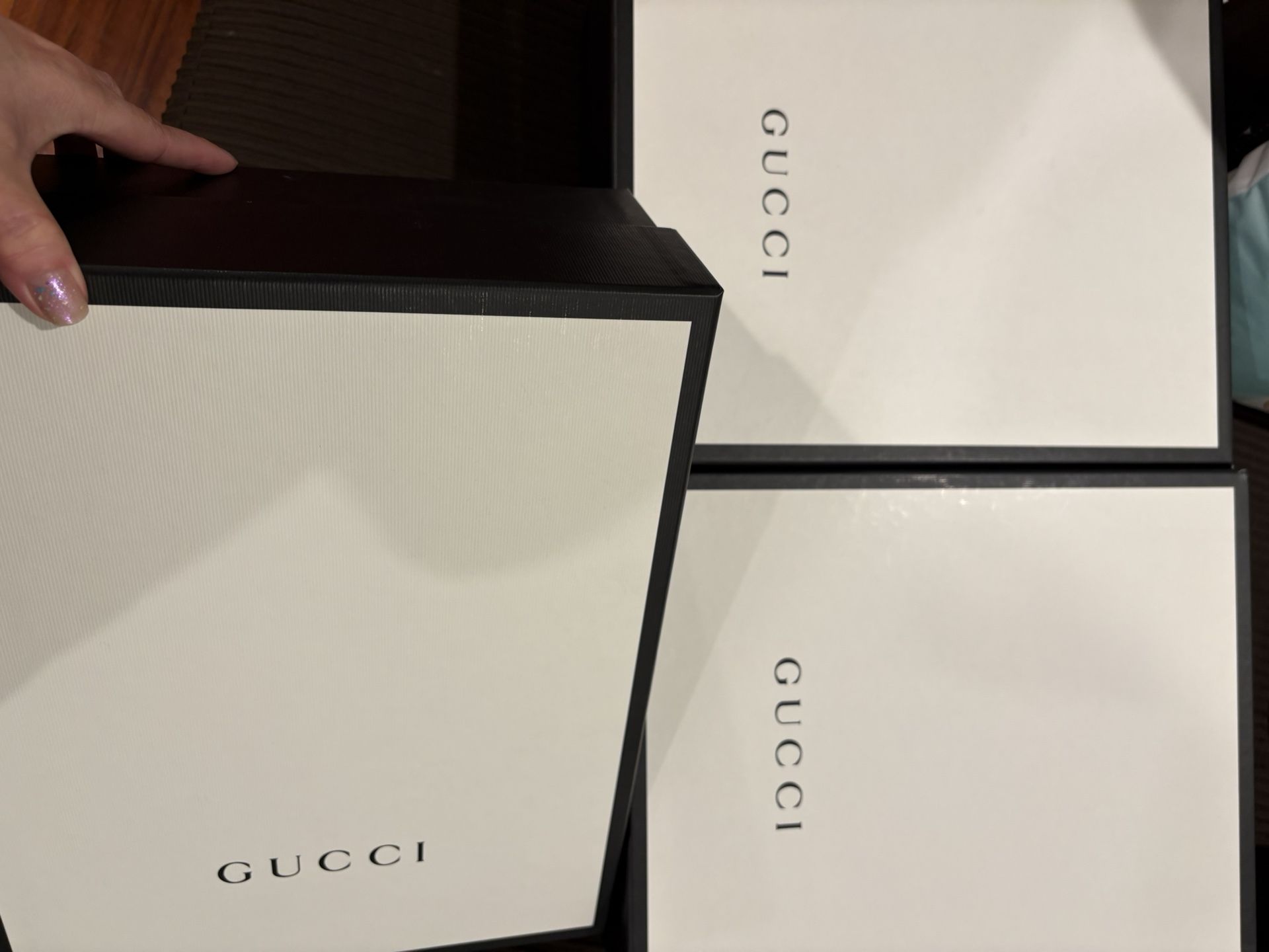 3 Gucci shoes boxes and 1 Gucci paper bag