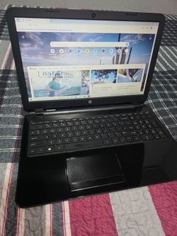 black HP laptop has a full-sized keyboard with a numeric keypad. This device is a clamshell design with a matte black exterior and a glossy black inte