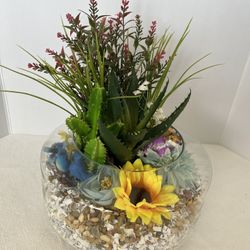 decorative succulent terrarium in a round glass bowl
