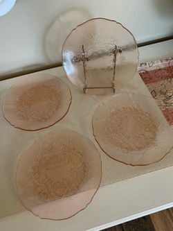 4 small pink glass plates