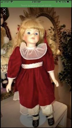 Beautiful porcelain doll with blonde hair, blue eyes, and a red dress. Comes with a doll stands, in good condition. Makes a great gift 🎁