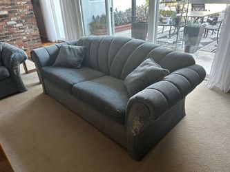 Two old custom made sofas with pillows