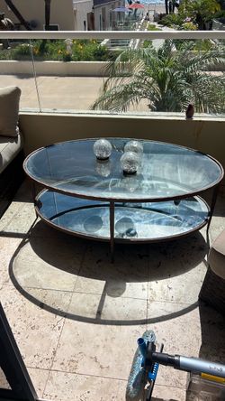 Oval two tier glass coffee table  48”