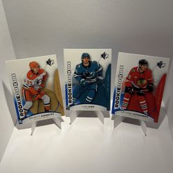 Beckett Sennecke, Cam Lund, Artyom Levshunov 2025-2026 Upper Deck SP Rookie Authentics