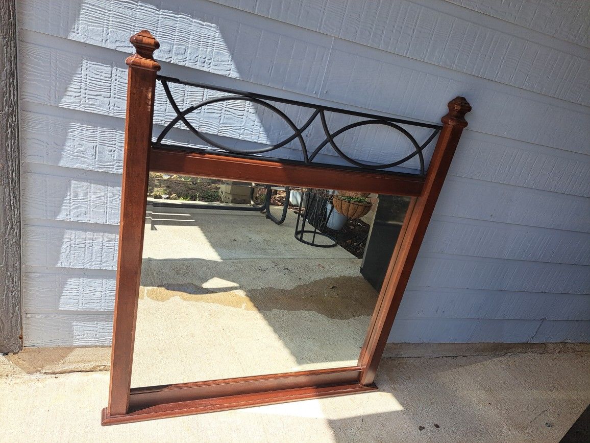 DAVIS INTERNATIONAL Contemporary Traditional Style Dresser MirrorMaterial: Cherry wood frame with metal scrollwork
Dimensions: Approximately 50.25 inc