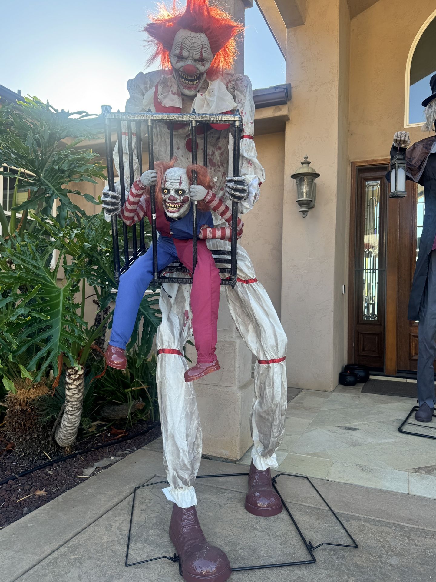 Clown Holding Baby Clown In Cage