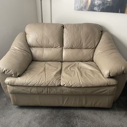 Tan-colored leather loveseat