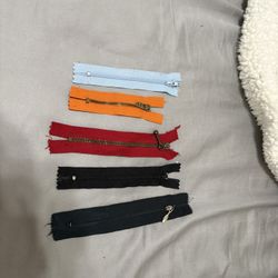 3.35” orange, 4.5” light blue, 5.25” red, 5” black, 5.5” black zippers $1 each 