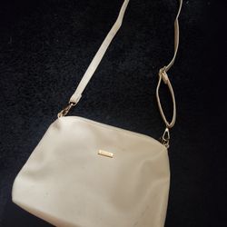 This is a white leather-look crossbody bag with a zipper closure and gold-tone hardware. The brand and material are not specifically identifiable from