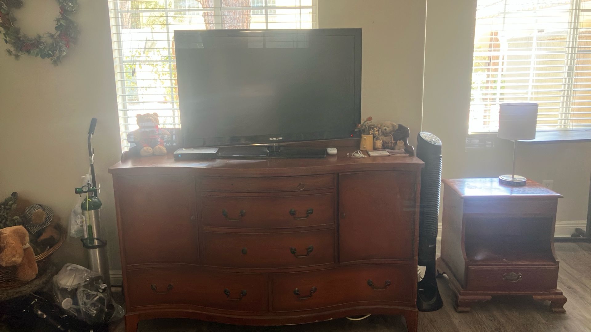 A Large Hutch, An Eight drawer dresser, a nightstand, an accent chair, a tea cart, and a 42 inch flatscreen TV.