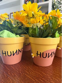 11 Pooh bear painted honeypots with fake flowers