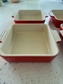 Authentic Le Creuset stoneware mini square baking dish in the classic Cherry Red color.