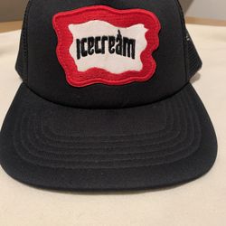 Icecream Inset Trucker Hat in black mesh with a red and white logo patch.  