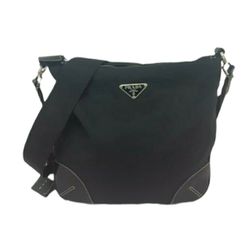 Prada Tessuto Cross Body Bag

This crossbody bag features a nylon body with leather trim, an adjustable flat strap, a top zip closure, and an interior