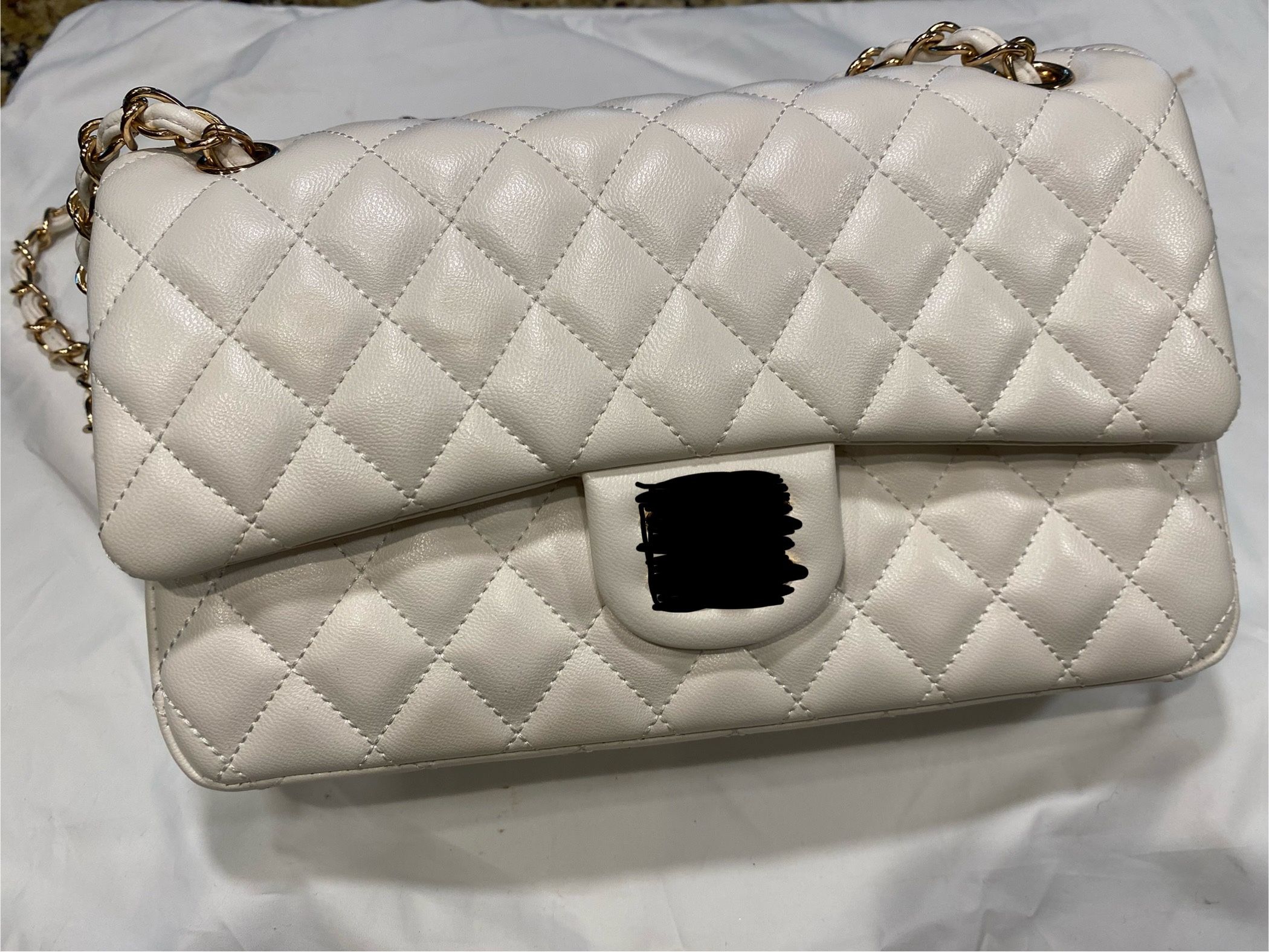 Quilted shoulder purse and gold hardware.