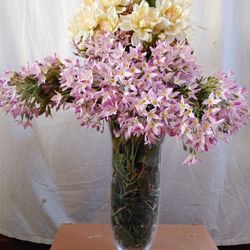 Artificial flower arrangement in glass vase