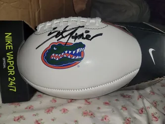 Autographed Nike Vapor 24/7 football is white with a Florida Gators logo.