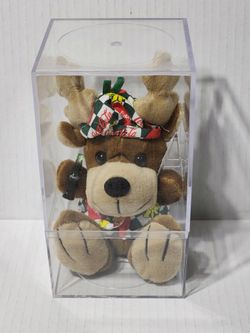 Reindeer with a COCA-COLA in Vest and Beanie The original Coca-Cola® brand