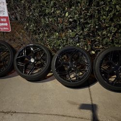 20" black aftermarket wheels with tires included.