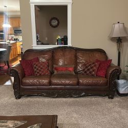 Ashley Furniture; 3 Brown Leather Couches, 2 Brown Accent Chairs, Marble And Wood Table And One Side Brown Coffee Table.