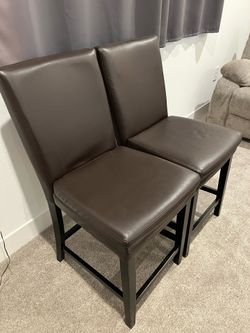 Two nice comfortable counter brown chairs.  When responding include what time you would like to see it today. Located by 1500 Goldfish Way by Delta sh