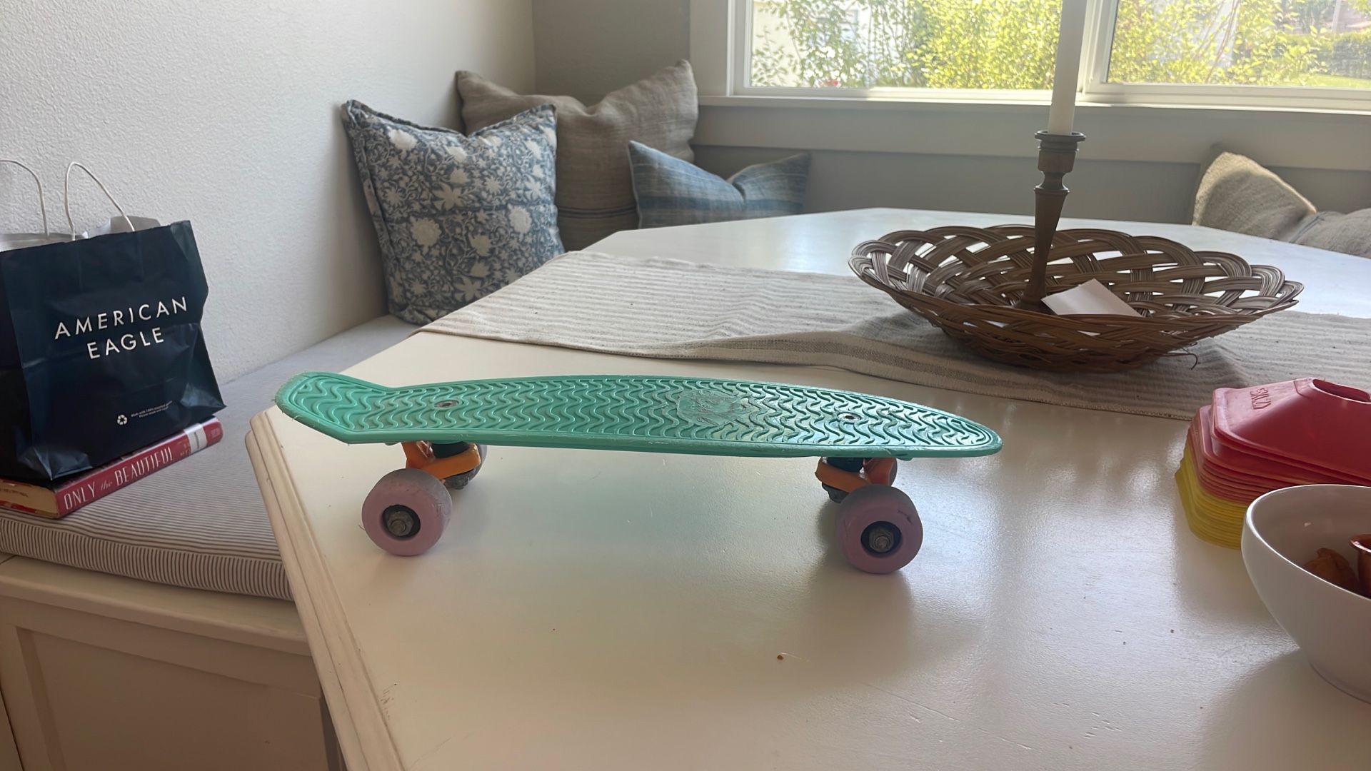Teal, Purple And Orange Mini Skate Board.