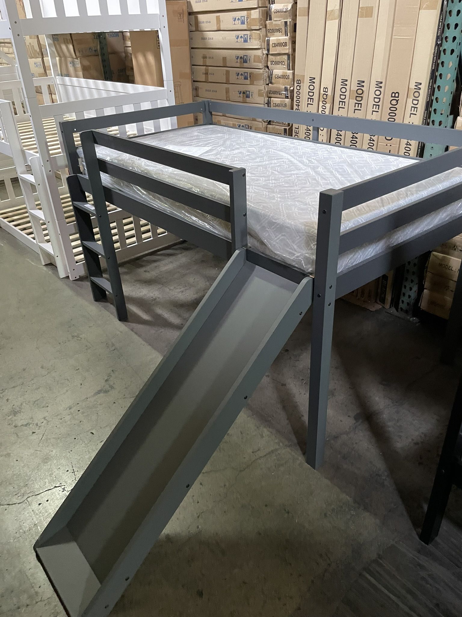 Twin slide bed. Available in grey & white. Assembly required. Assembly not included. Tax included. Free local delivery. With out mattress-$299 With t