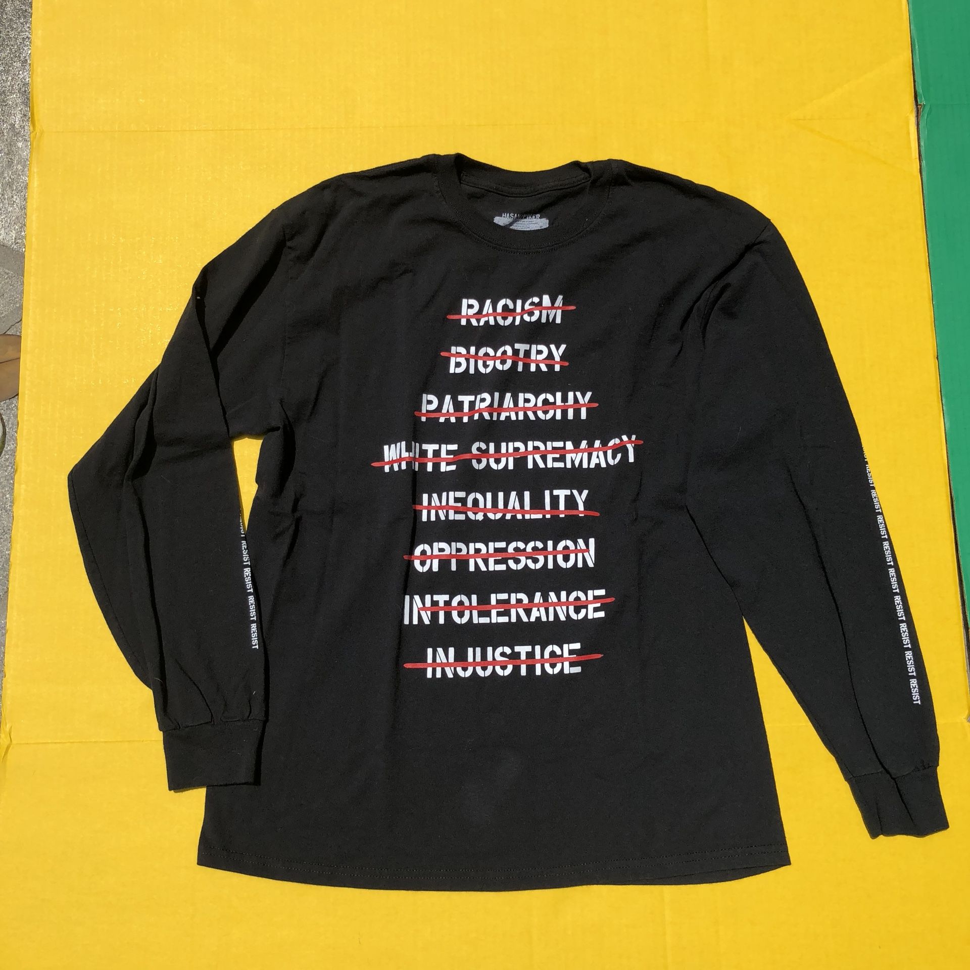 Hasan Piker NONE OF THE ABOVE Tee