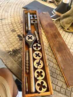 tap and die set used for cutting and repairing metal screw threads.