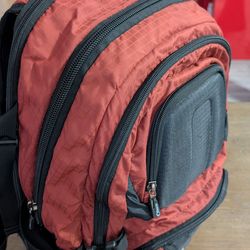Orben Thousand Mile Backpack in a rust red and black color