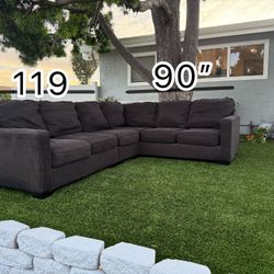 Dark gray L-shaped couch/sofa in very good condition.