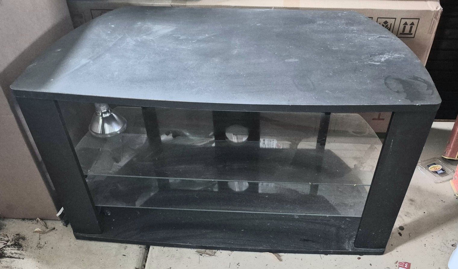Stand
Sturdy black TV stand with glass shelves