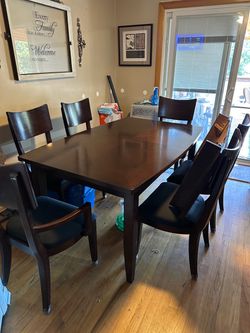 Dark brown dining table, six chairs.
