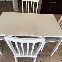 Dining table with 4 chairs, solid  Hardwood & MDF  with fabric seat .   Modern white table with steel legs 49 1/4”x29 1/2 "  New open box