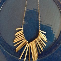 Stylish silver tone necklace with unique design.