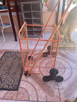 Sturdy 3-wheel cart (3 wheels in the back and 3 in the front) in good condition, capable of carrying various items.