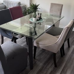 Glass Dinning Table With Chairs 63 Inches In Length And 35.3 Inches Wide