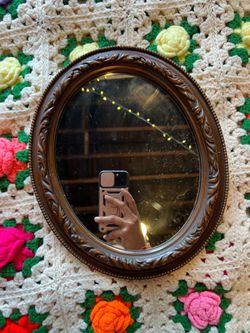 Ornate rustic 70’s oval mirror on wood frame