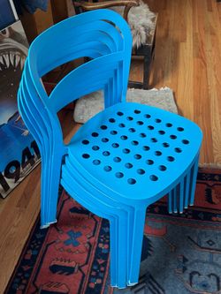 6 Blue Stackable Metal Chairs.
