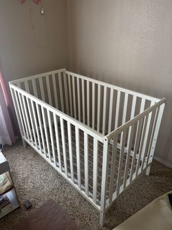 Modern white wooden baby crib