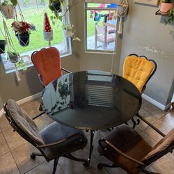 ROUND BLACK GLASS/ROD IRON DINING TABLE. 