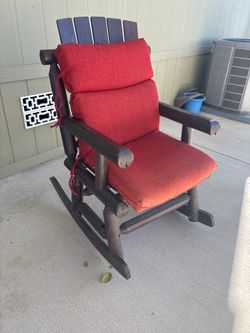 Wooden rocker with red cushions