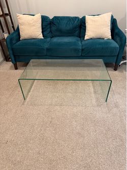 Green Couch and Glass Coffee Table