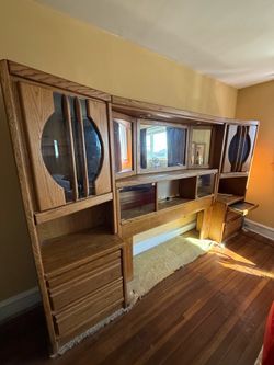 Large, solid oak bedroom wall unit headboard featuring integrated storage.