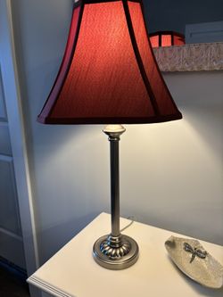 Traditional style metal lamp with a fluted column and stylish maroon shade