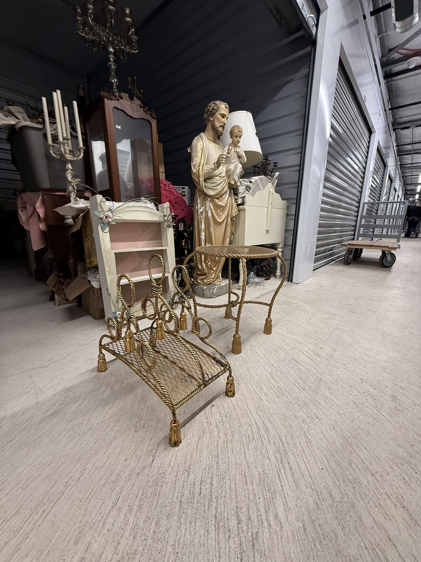 Gold rope twist decorative stool with tassel feet and Ornate gold-toned Italian mid-century magazine holder with rope and tassel details.