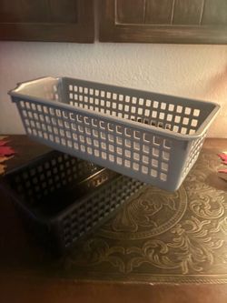 2 grey & Black plastic storage basket with a rectangular, slotted grid design