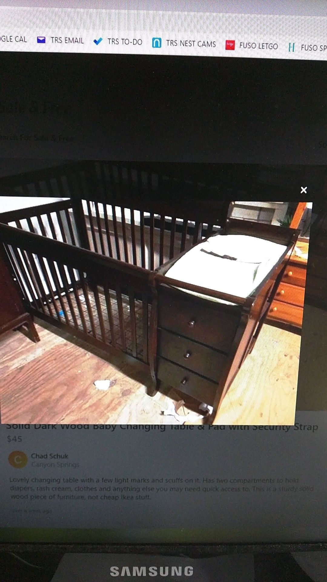 Solid dark wood baby changing table & pad with security strap.