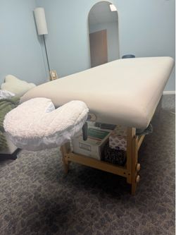 Stationary massage table with bottom shelf