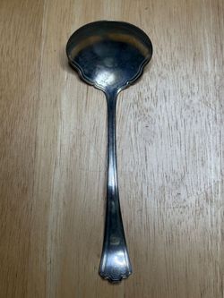 Vintage silver plated gravy ladle R.C co 1928. There is a small abrasion at the top of spoon which is barely noticeable.